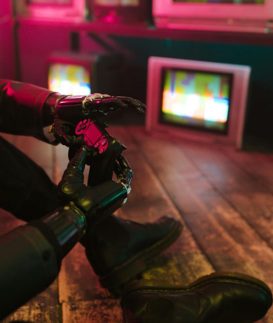 Futuristic cyberpunk vibe with a prosthetic hand holding a gaming joystick. Neon lights and retro TVs.
