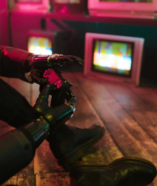 Futuristic cyberpunk vibe with a prosthetic hand holding a gaming joystick. Neon lights and retro TVs.